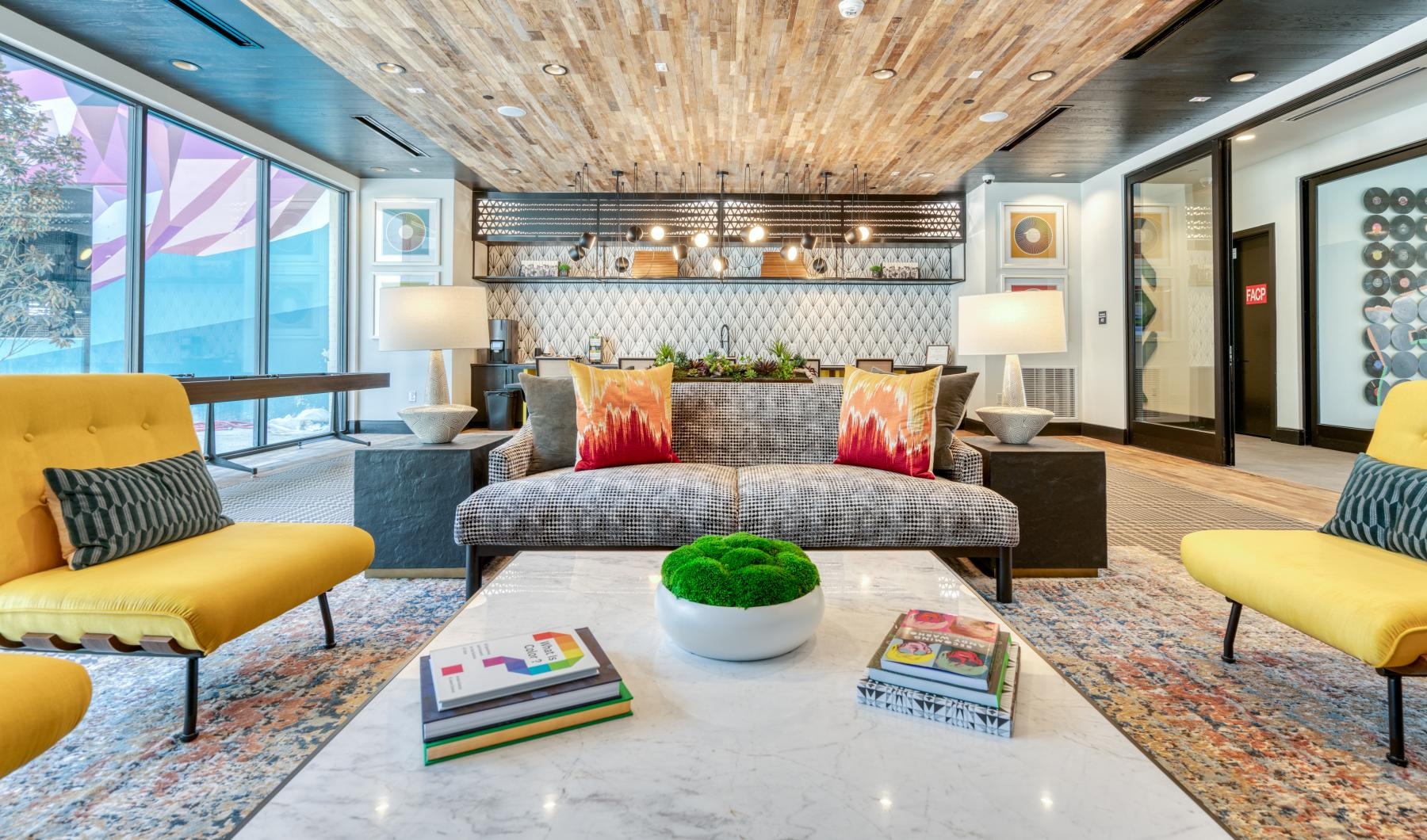 Find your perfect fit at Atlas North Lamar a living room with a large chandelier and a large window